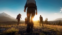 Eine Wandergruppe bei Sonnenaufgang